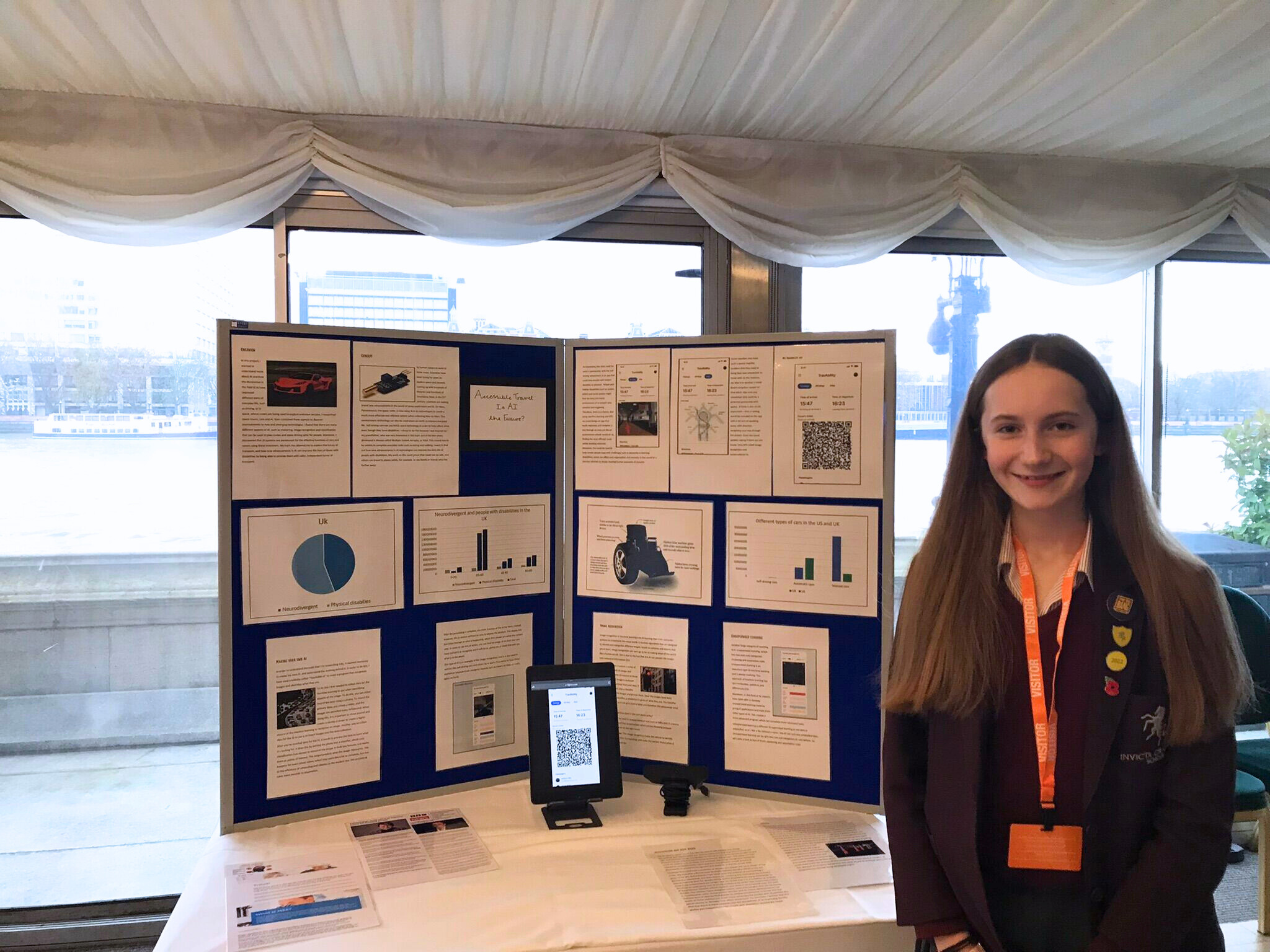 Image of Betsy in front of board showcasing her award