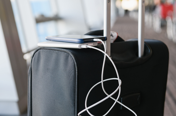 Suitcase with a power bank and mobile phone on top of it