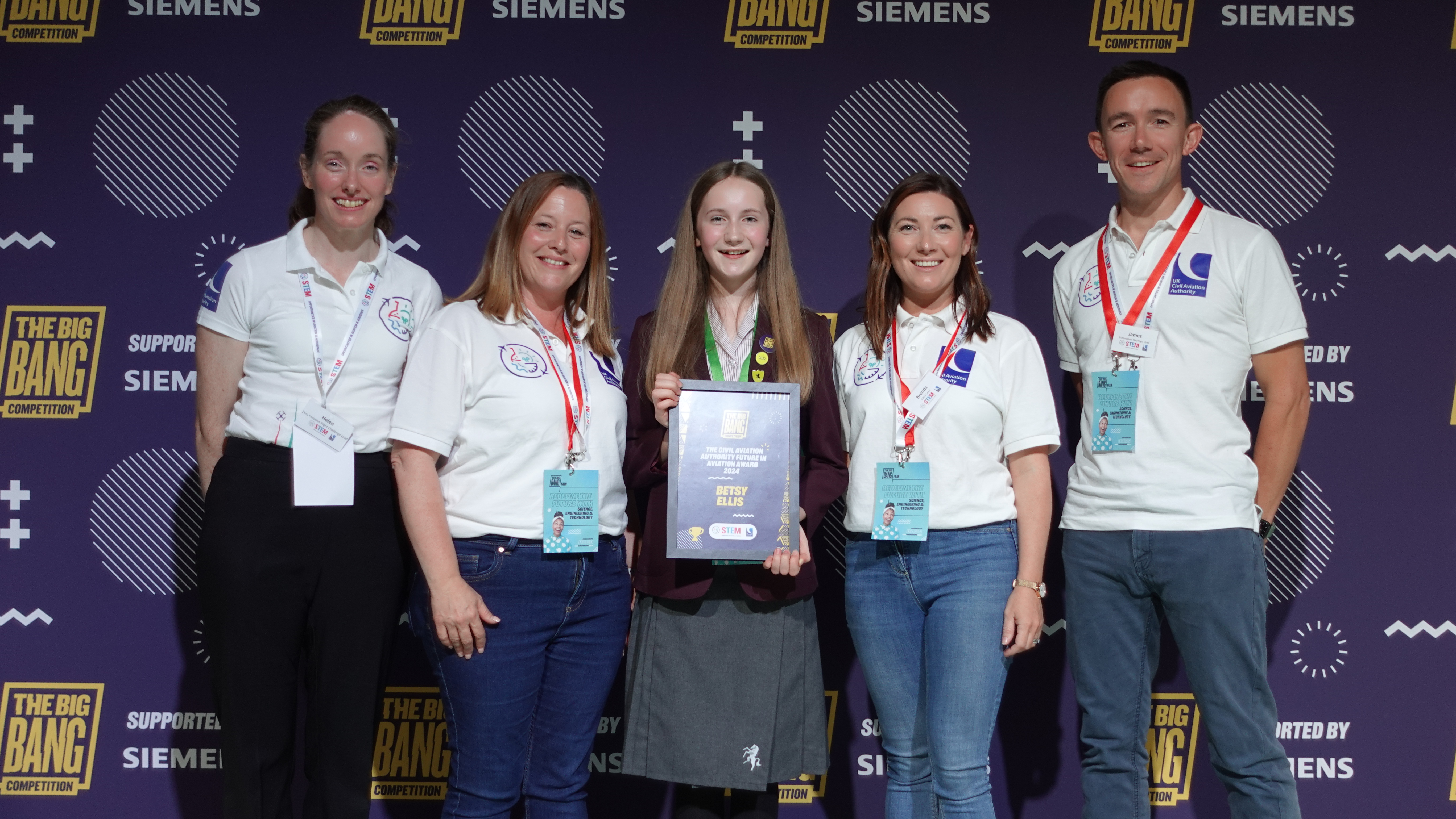 Image of Betsy Ellis (middle) holding her award