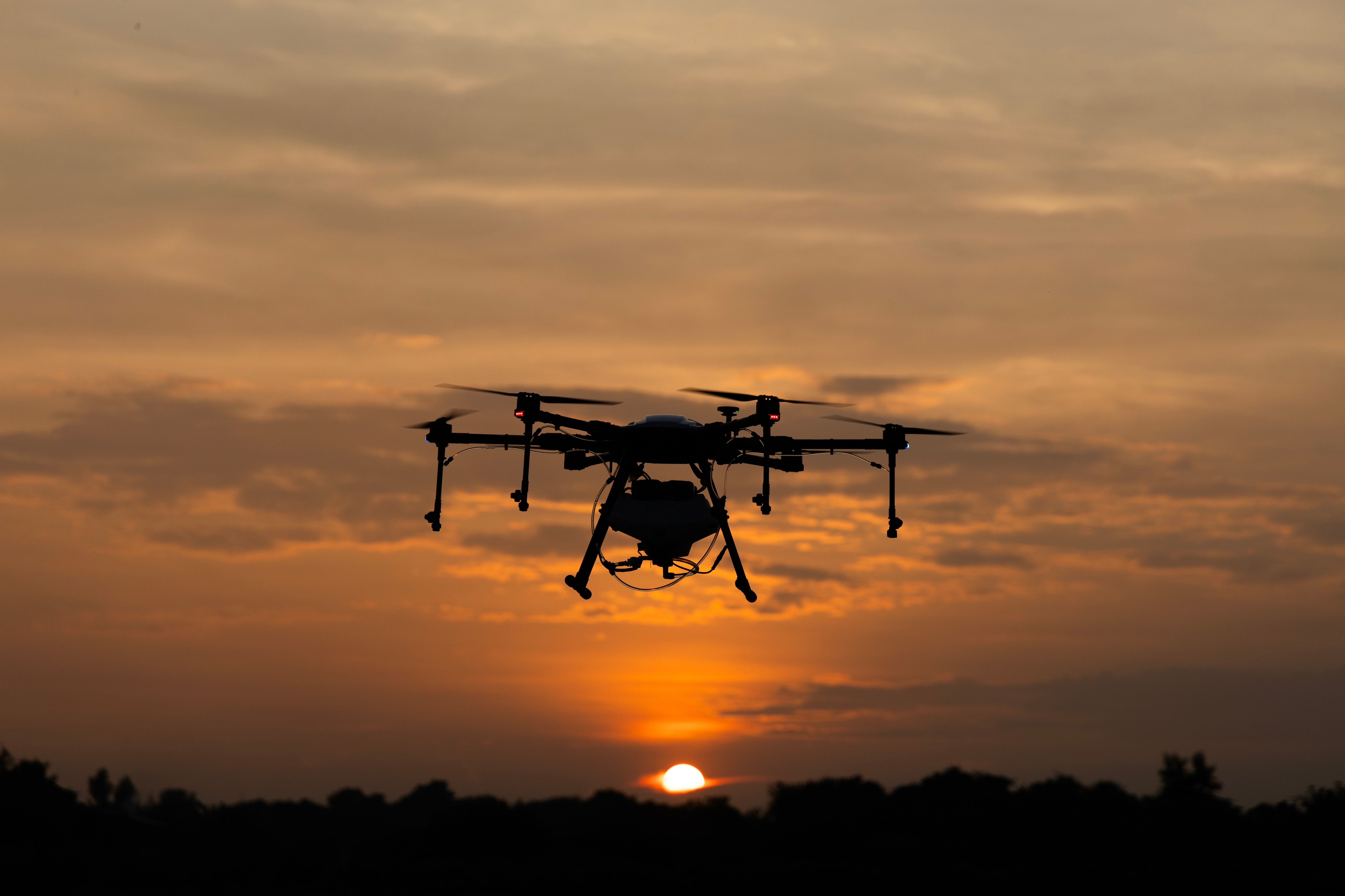 Drone flying at sunset